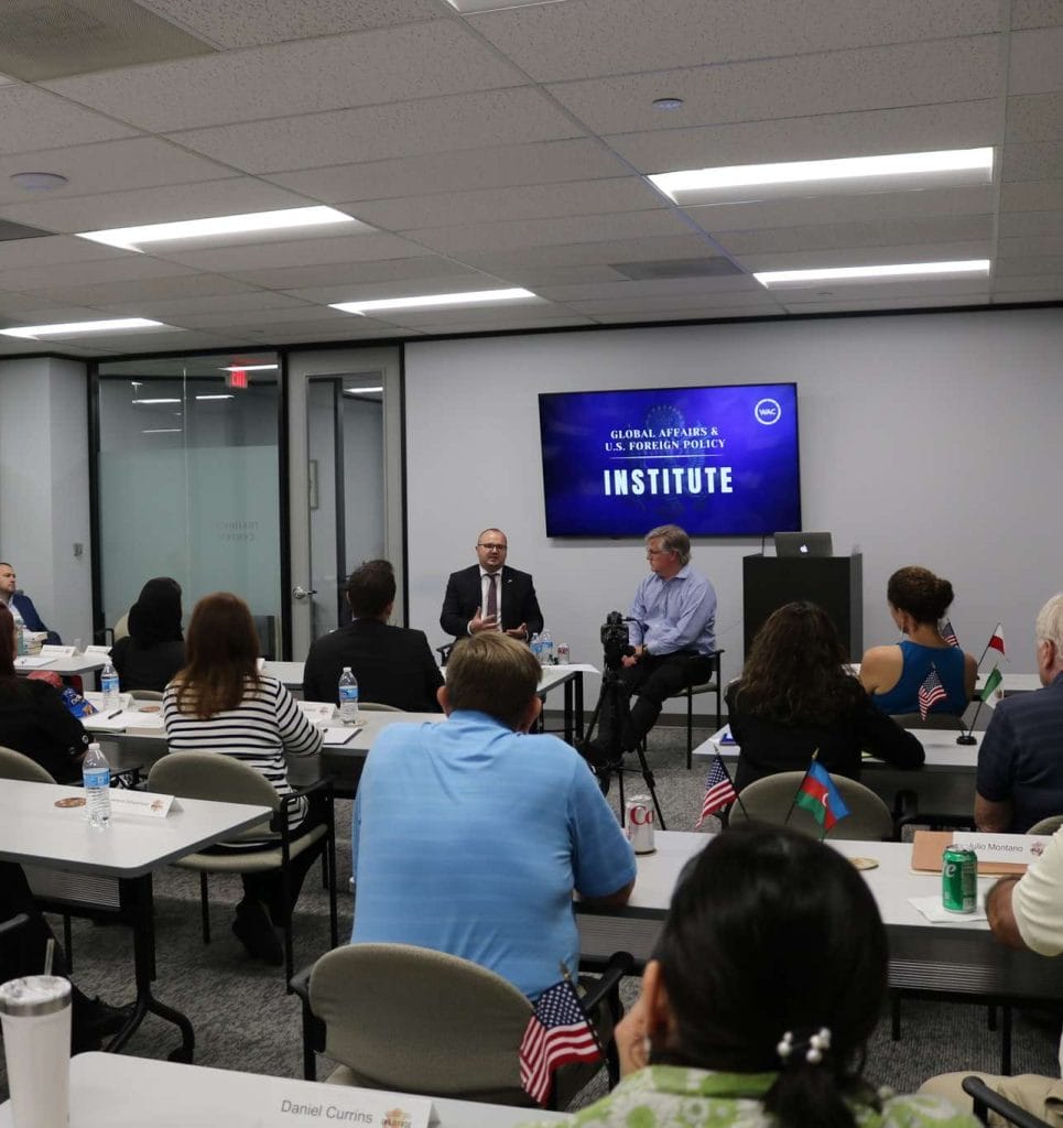 Group of people in room listening to speaker